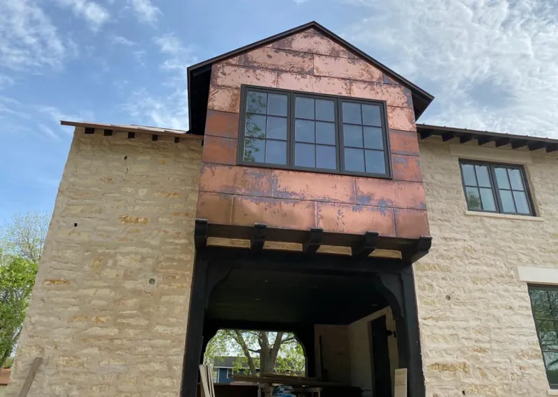 Copper metal panel facade on a stone building for Skylight Installation in Oak Grove